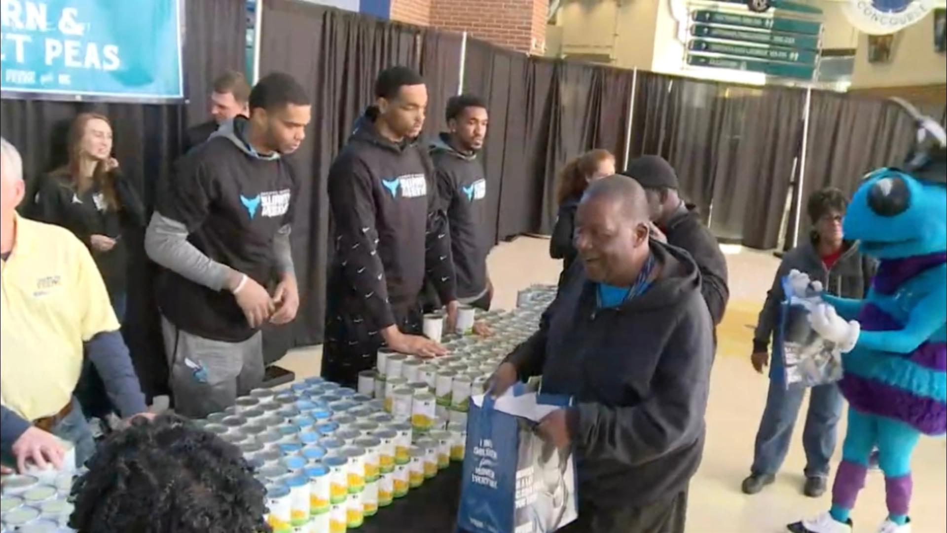 Charlotte Hornet players, coaches and executives joined volunteers to pack meals that will be sent to 1000 CMS families for Thanksgiving.