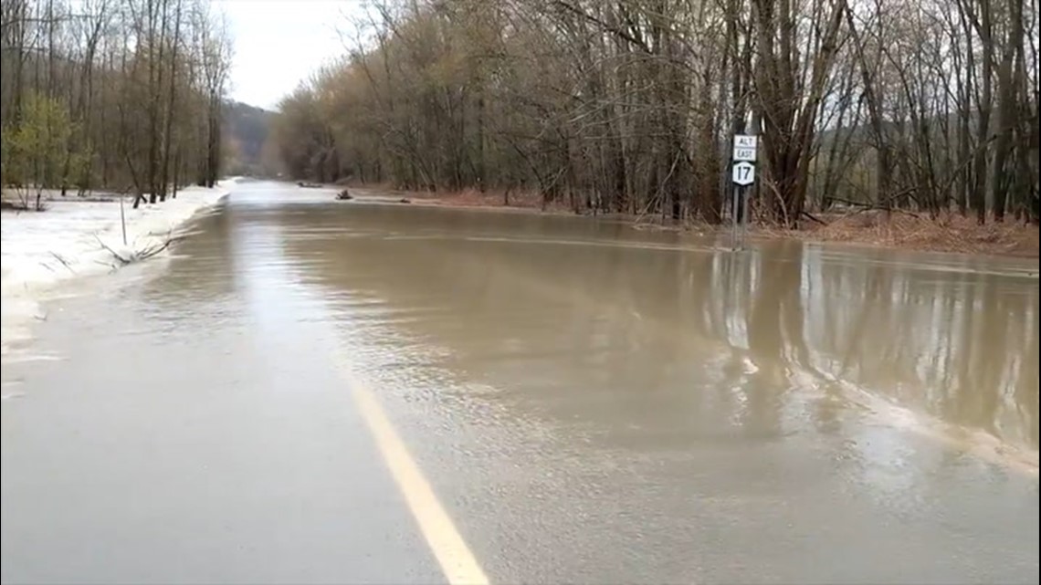 Overflowing river floods road