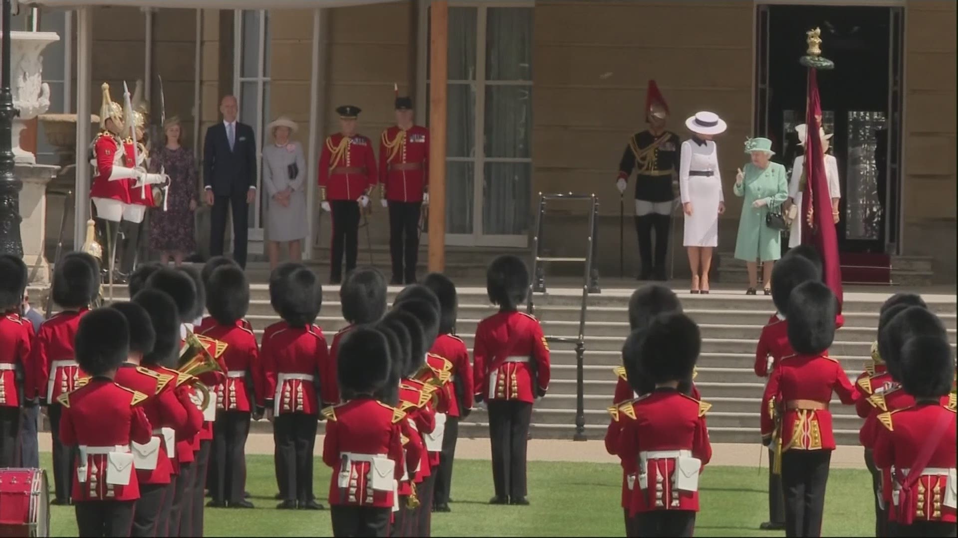 President Donald Trump and his wife Melania were greeted on the grand lawn of Buckingham Palace by Queen Elizabeth II and inspected the Guard of Honor formed by the Grenadier Guards wearing the traditional bearskin hats.