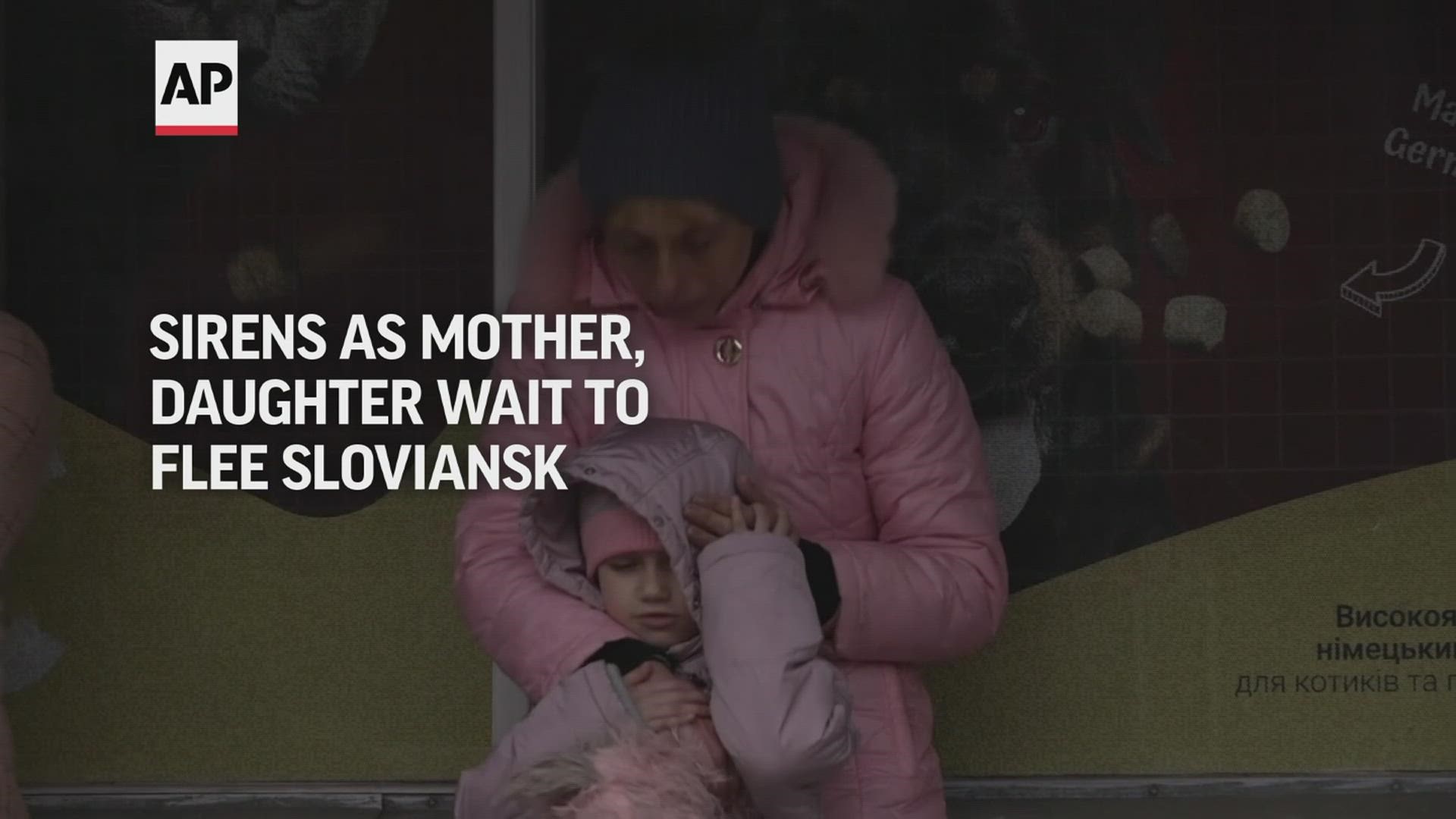 A mother and her young daughter, carrying only a few bags, waited patiently in downtown Sloviansk on Saturday morning to try and catch a vehicle to flee.