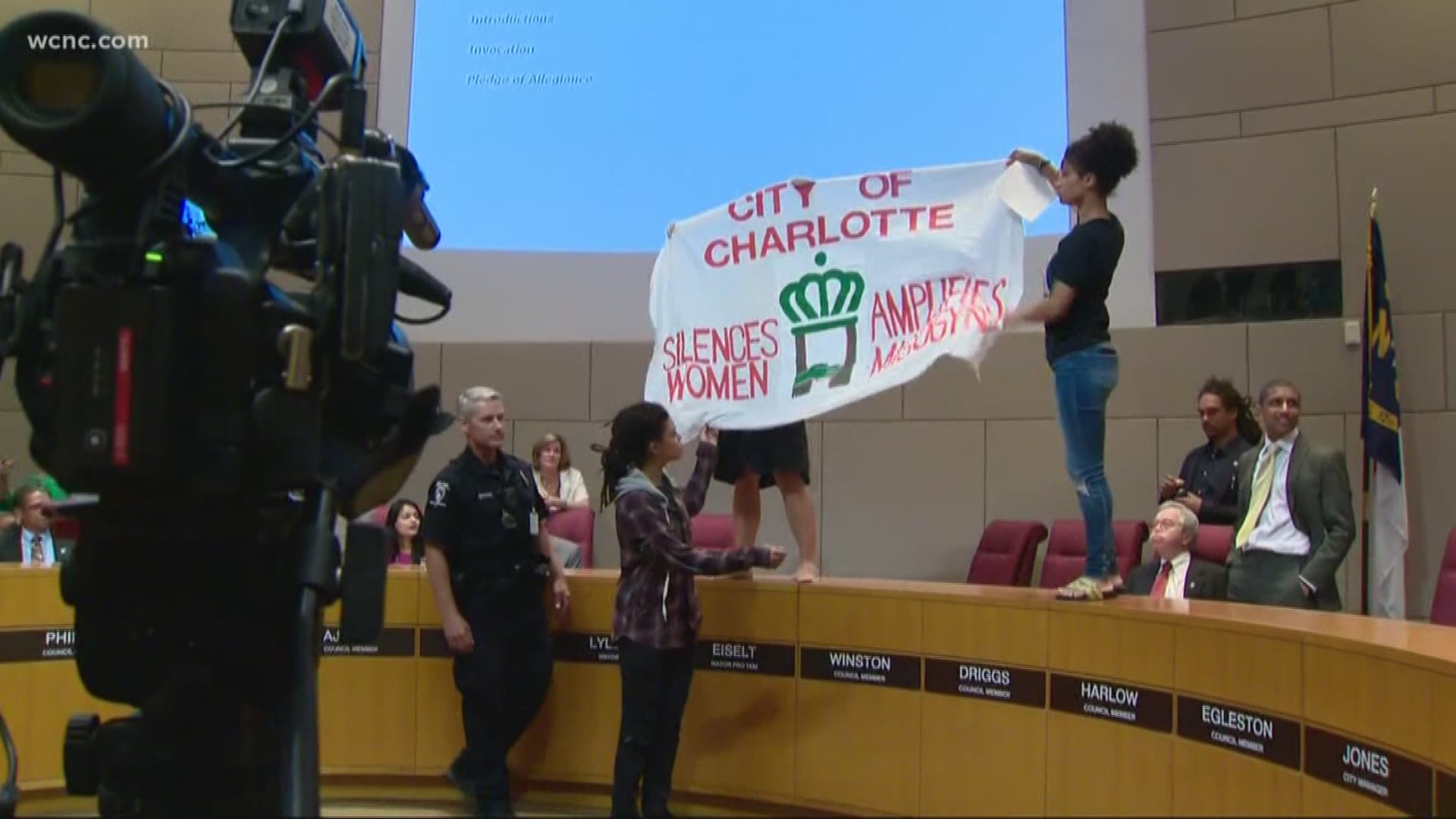Protesters jumped up on the podium with a huge banner, just as Mayor Vi Lyles was getting that meeting underway.
