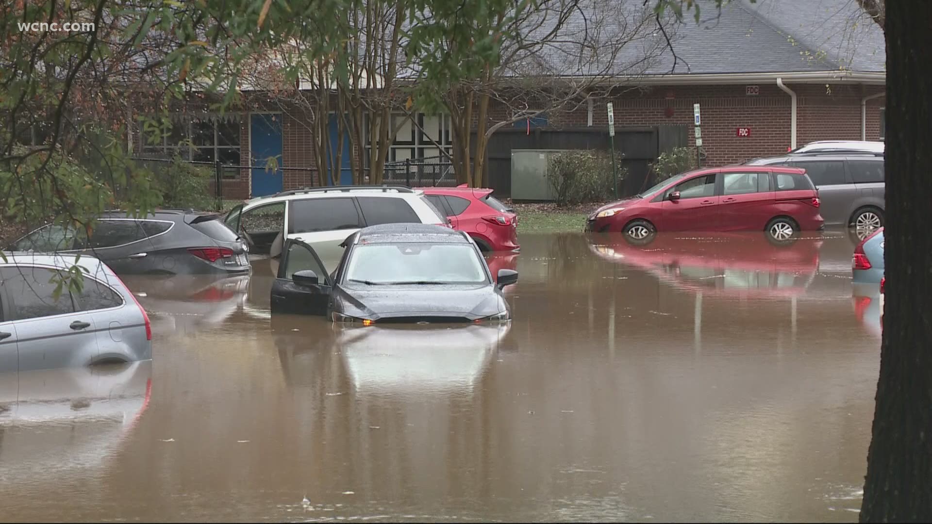 Cars were almost unable to pick up students in the parking lot because of the flood waters.