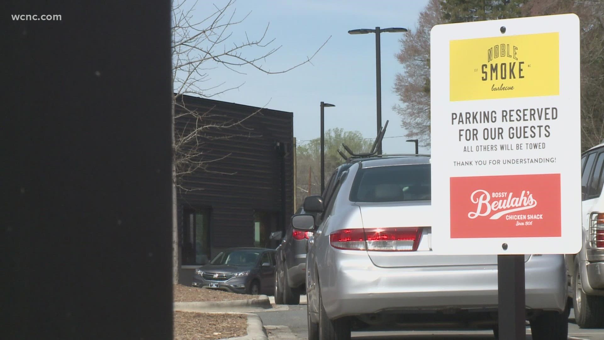 A Charlotte business owner is accusing a restaurant of hurting her business by preventing her customers from using a parking lot they share.