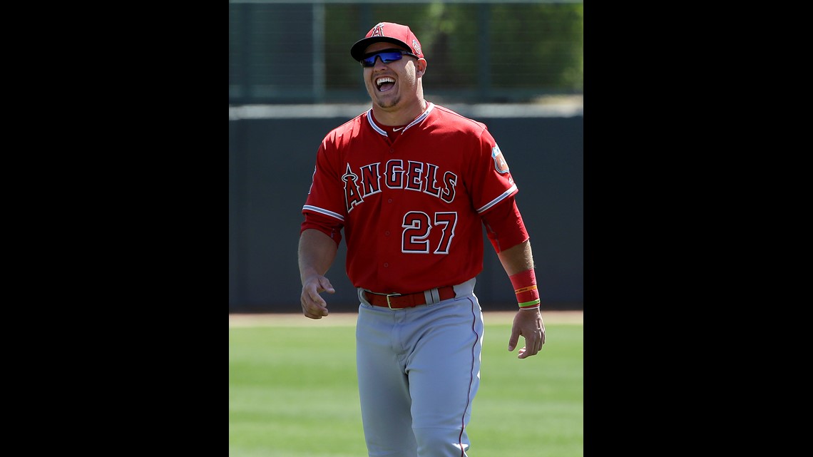 KANSAS CITY, MO - JUNE 18: Los Angeles Angels center fielder Mike Trout  (27) wears the team's Samurai Hat in the dugout after hitting a solo home  run during a MLB game