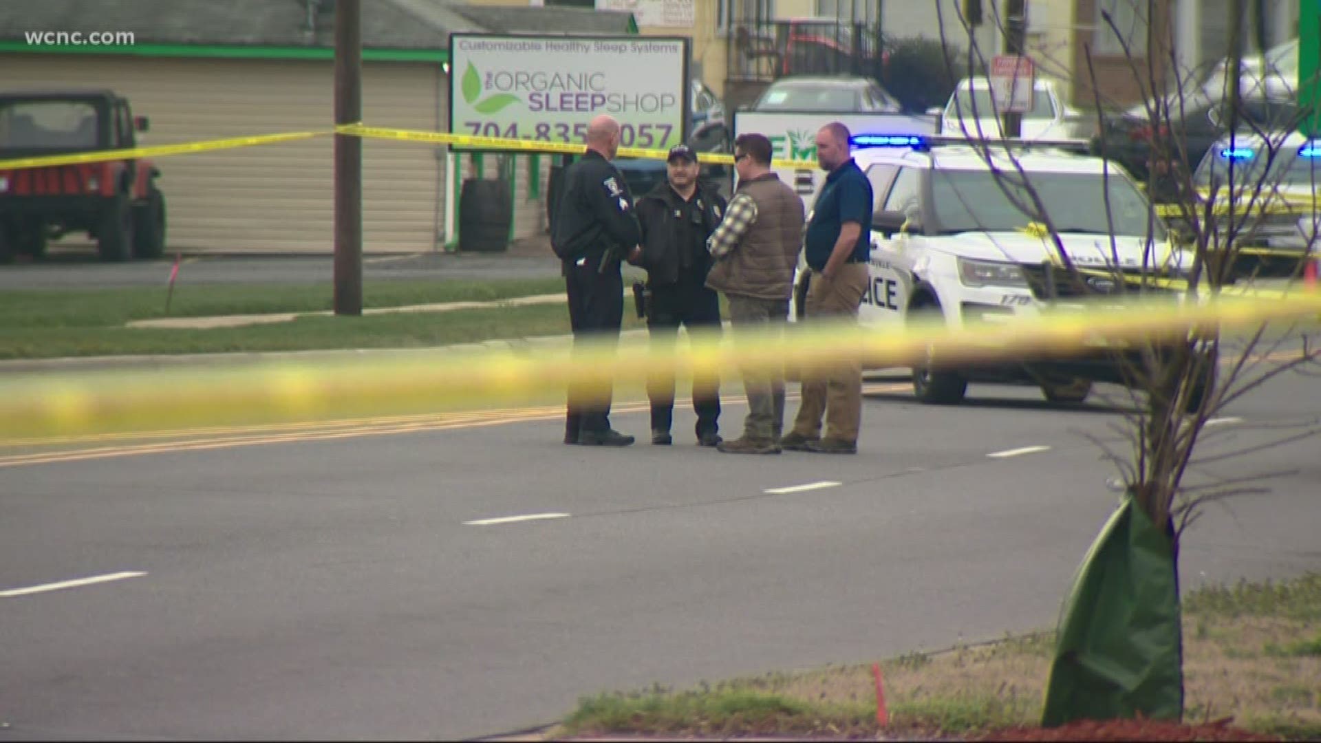 Two Pineville Police officers shot at the man waving a gun at traffic, the police department confirmed Saturday.