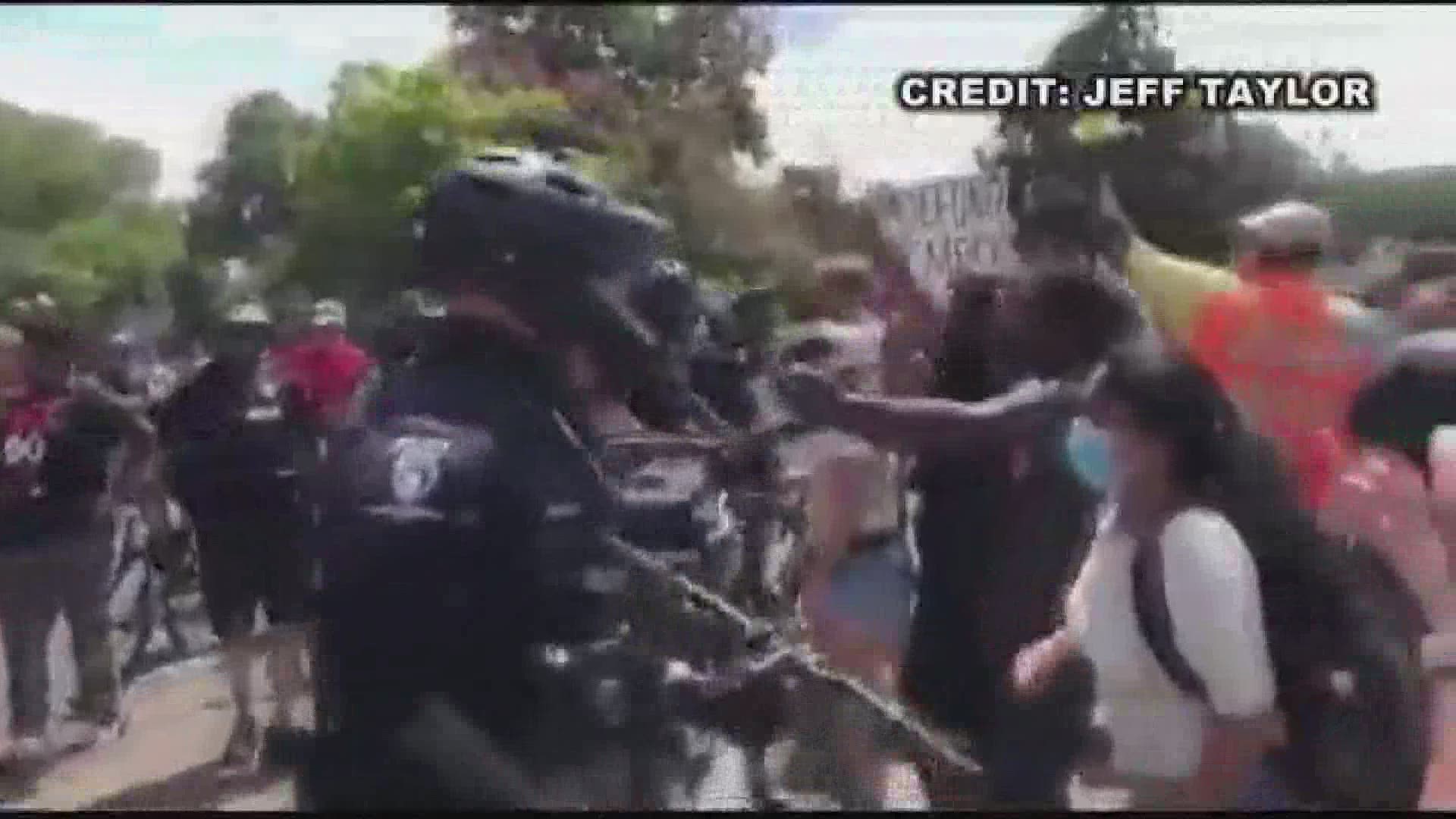 An officer was seen using pepper spray on a group of protesters. CMPD said it was in response to a protester attempting to steal an officer's bike.