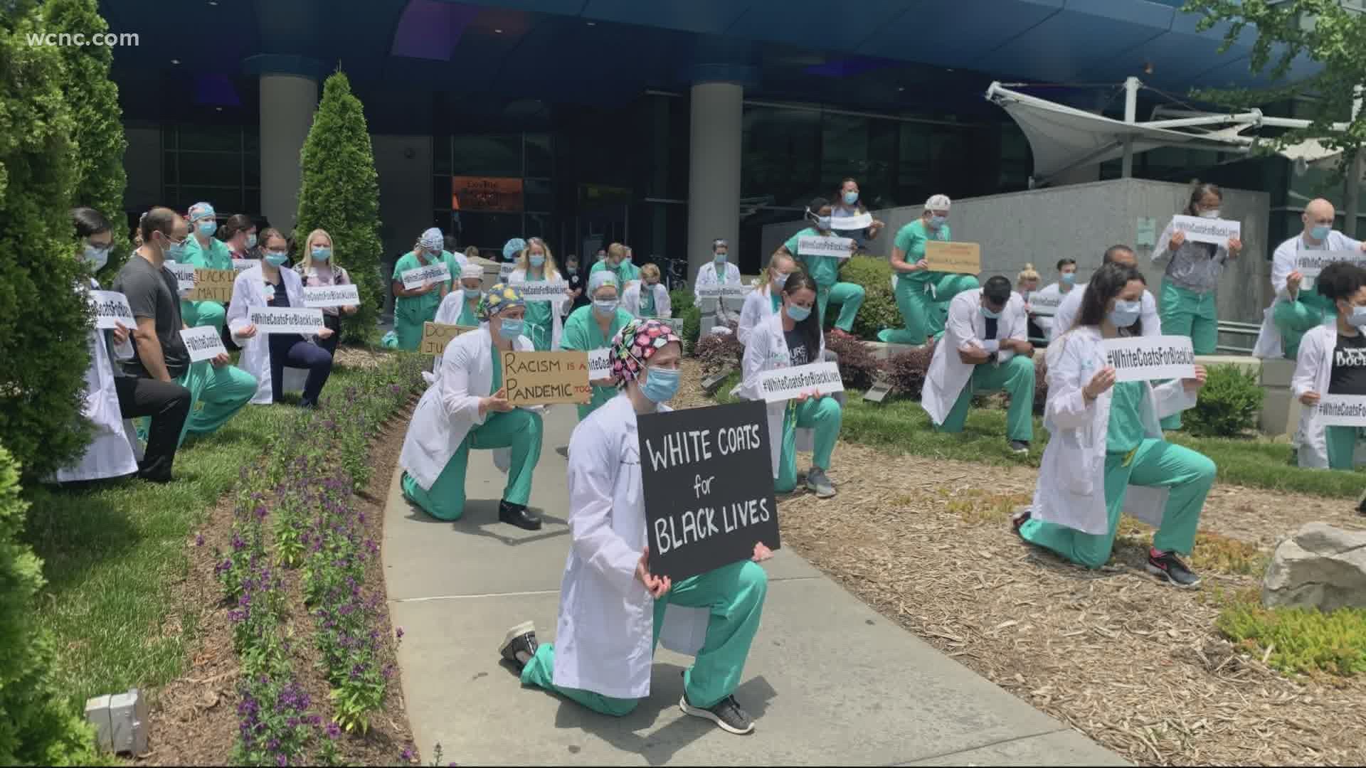 Doctors, nurses and staff took a knee for a moment of silence as a way to honor George Floyd and speak out against racial injustice.