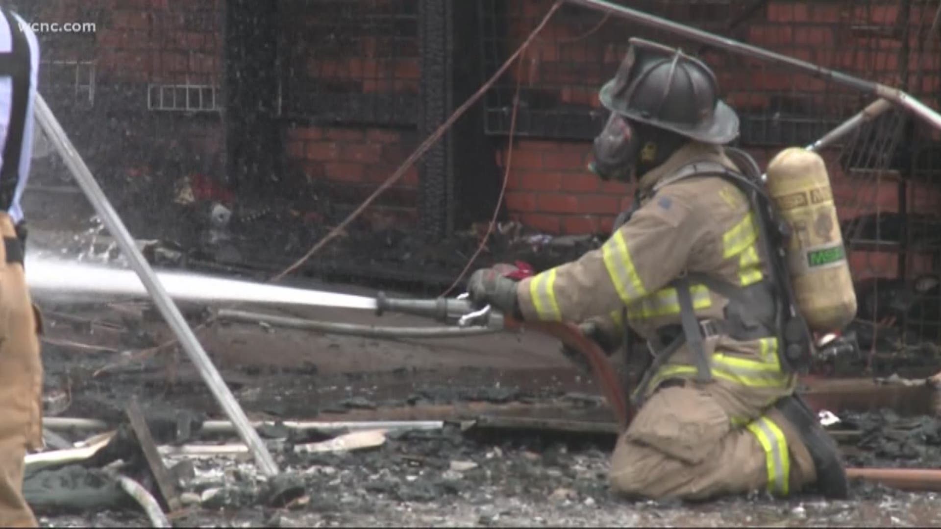 A firefighter was injured when materials from a collapsed roof fell on his head while battling a large fire in downtown Kannapolis Thursday.