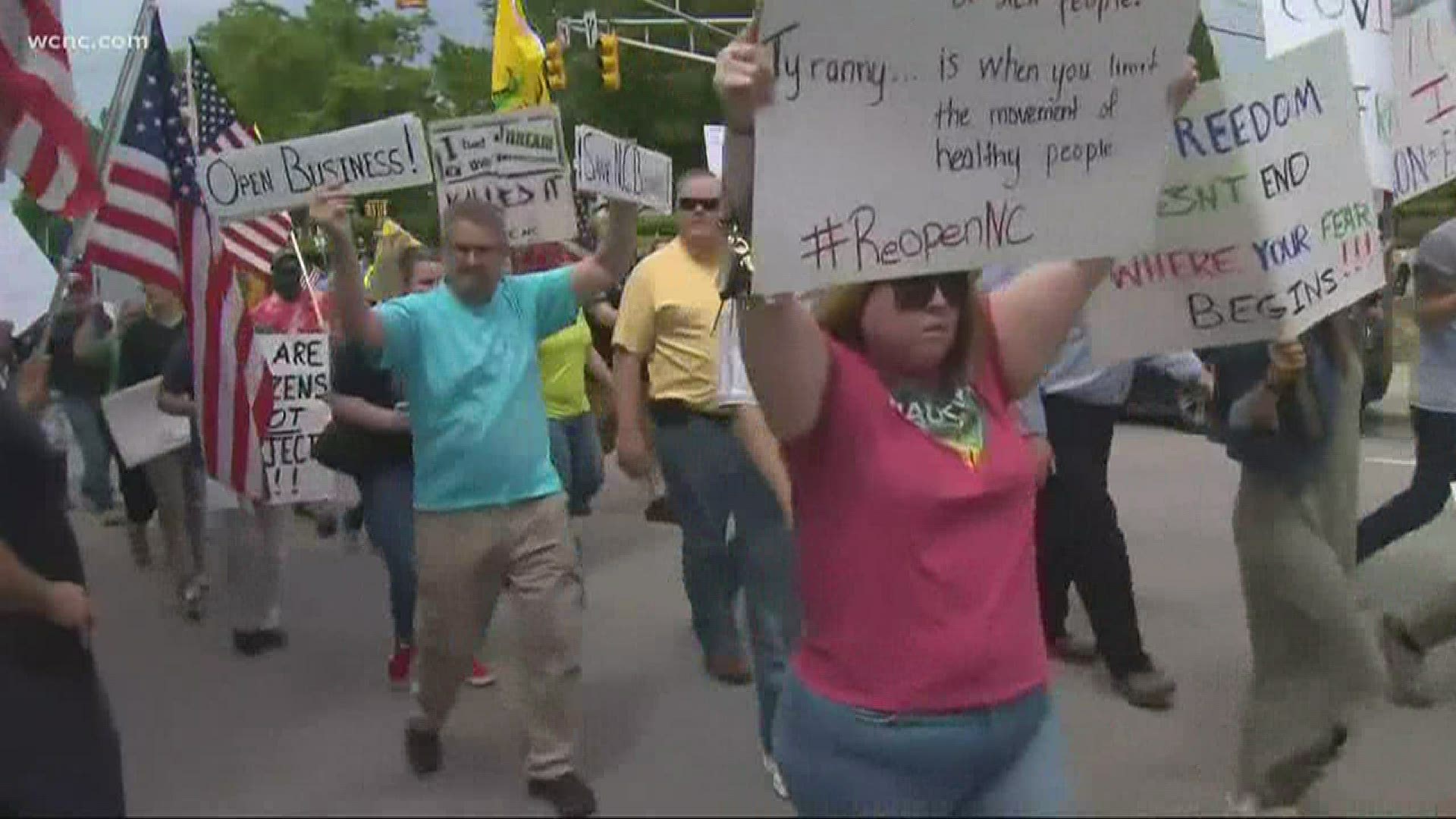 Dozens from ReOpen NC protested through the streets of Uptown Charlotte Friday afternoon.