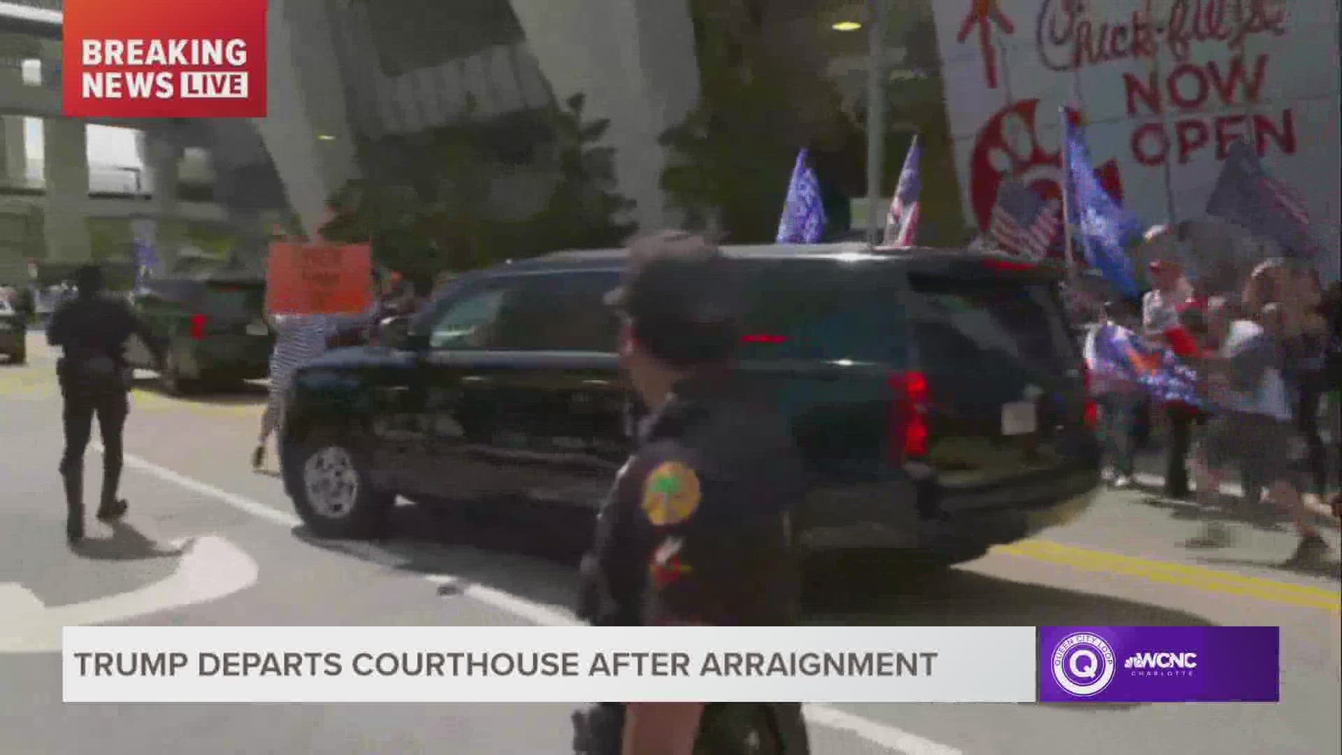 A man dressed in the costume of a prisoner stepped in front of the motorcade carrying former President Donald Trump from the federal courthouse in Miami.