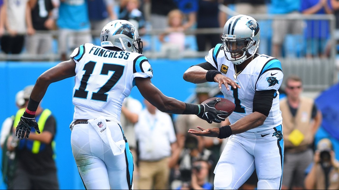 Cam Newton of the Carolina Panthers is sacked by Efe Obada of the