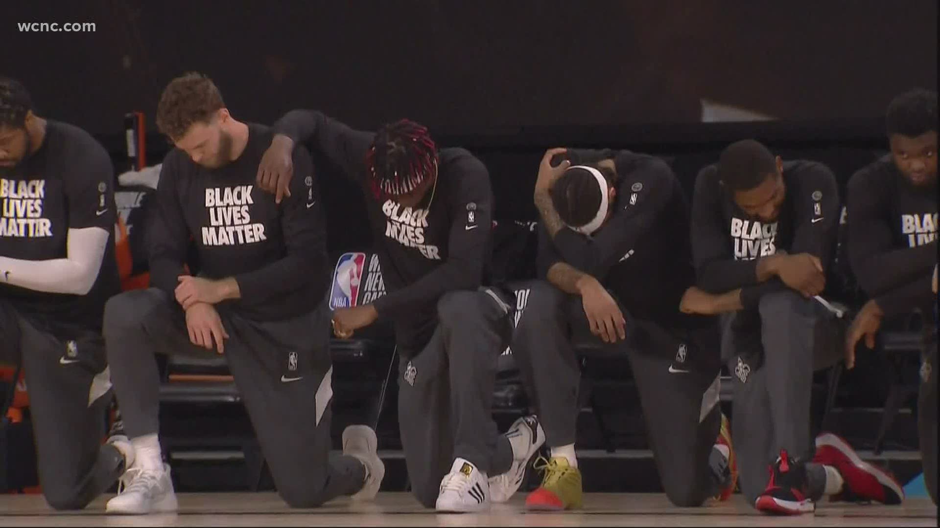 In the NBA's first meaningful game in months, all players and coaches on both teams knelt and locked arms in solidarity with Black Lives Matter.