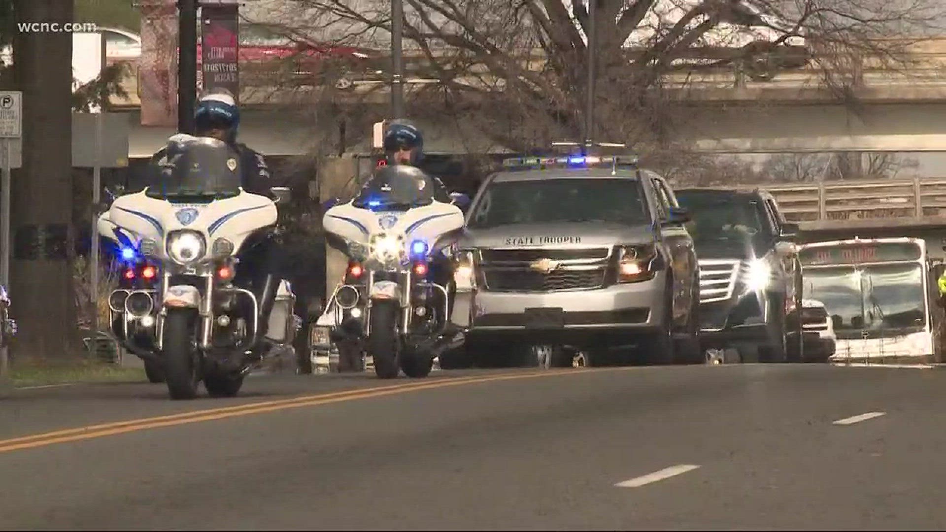 As the motorcade escorting Reverend Billy Graham made its way through toward Charlotte Saturday afternoon, a large crowd of admirers took to the streets of uptown to honor the man many knew as "America's Pastor."