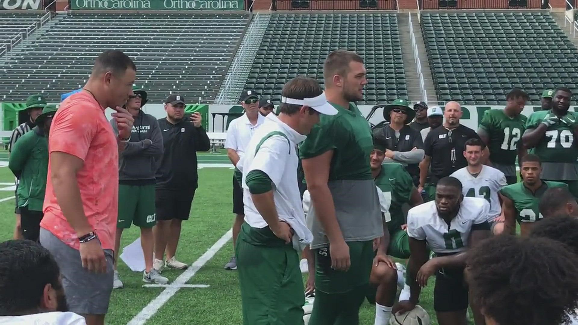 Charlotte 49ers offensive lineman Dejan Rasuo was surprised with a scholarship at practice Friday by former teammate Alex Highsmith.