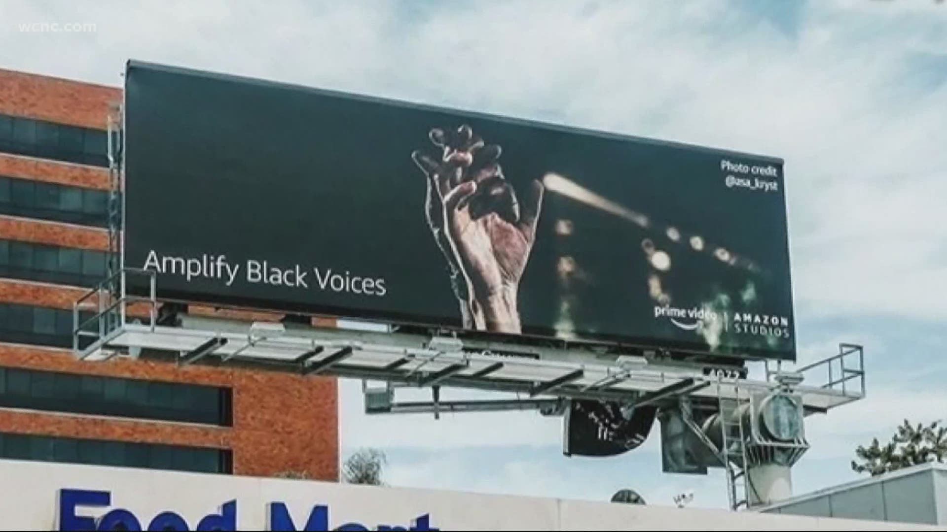 An image taken by Charlotte visual storyteller Asa Kryst during a Queen City protest is now getting recognized by Amazon on billboards around Los Angeles.
