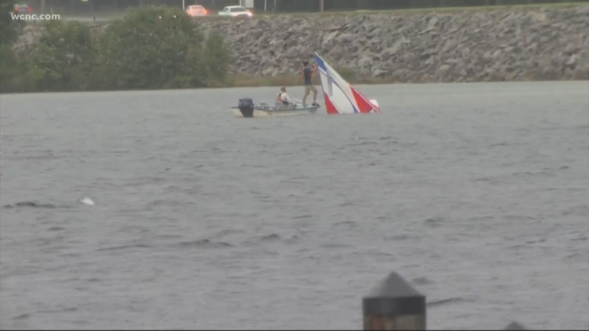 Emergency crews pulled dozens of members from a sailing class to safety after their boats overturned on Lake Norman.