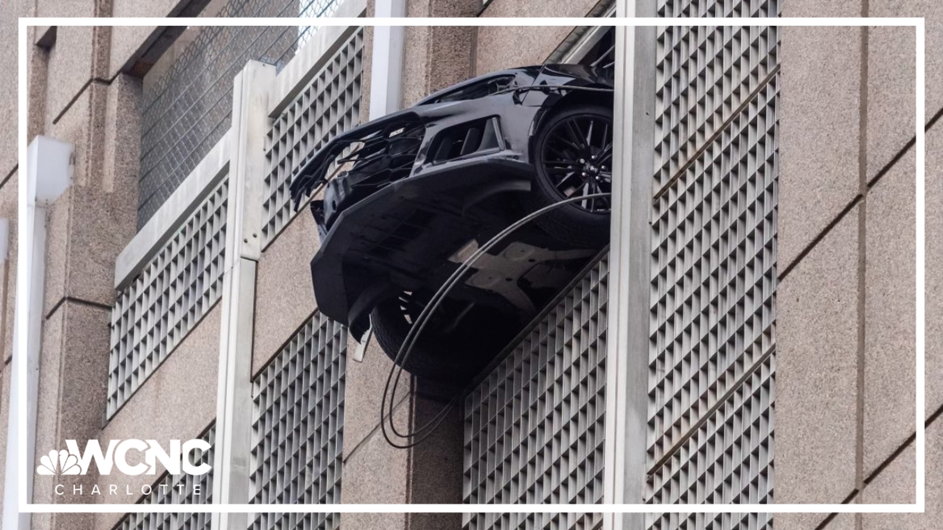 A car rolled out the wall of a parking deck in Uptown Charlotte on Thursday.
