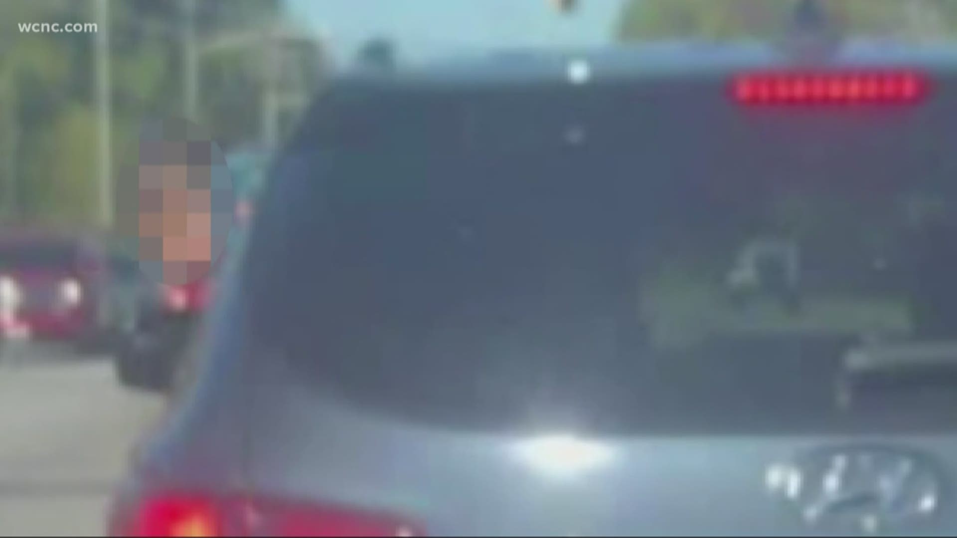 The woman who took the video said the girl wasn't only hanging out of the window but was also walking around the back seat as the car was moving.