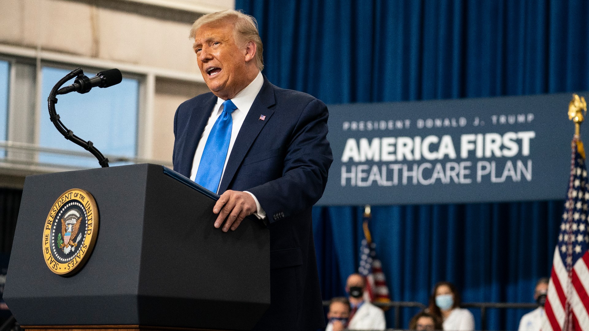 President Donald Trump signs two healthcare executive orders during a campaign event in Charlotte, North Carolina Thursday.