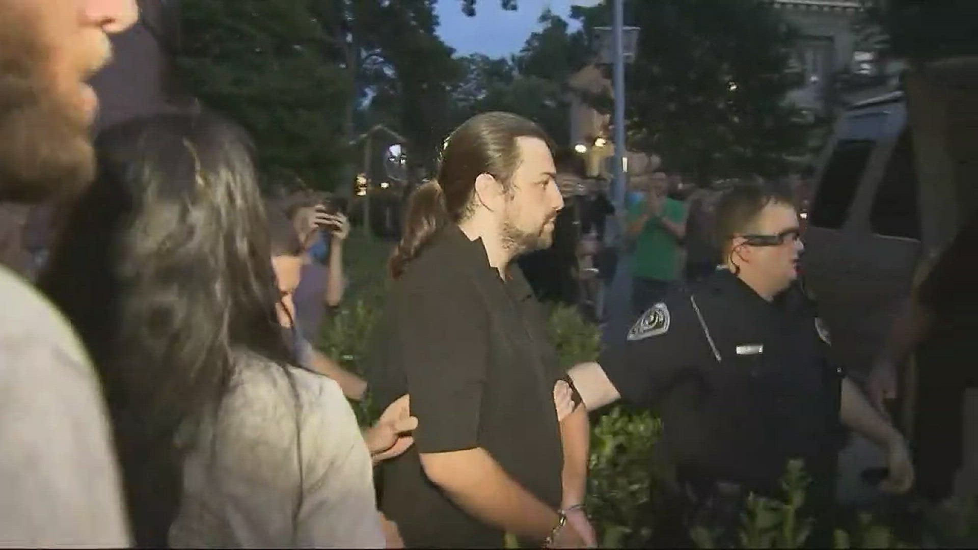 Tempers flaired and there were brief clashes with police as hundreds rally demanding the removal of a confederate statue.