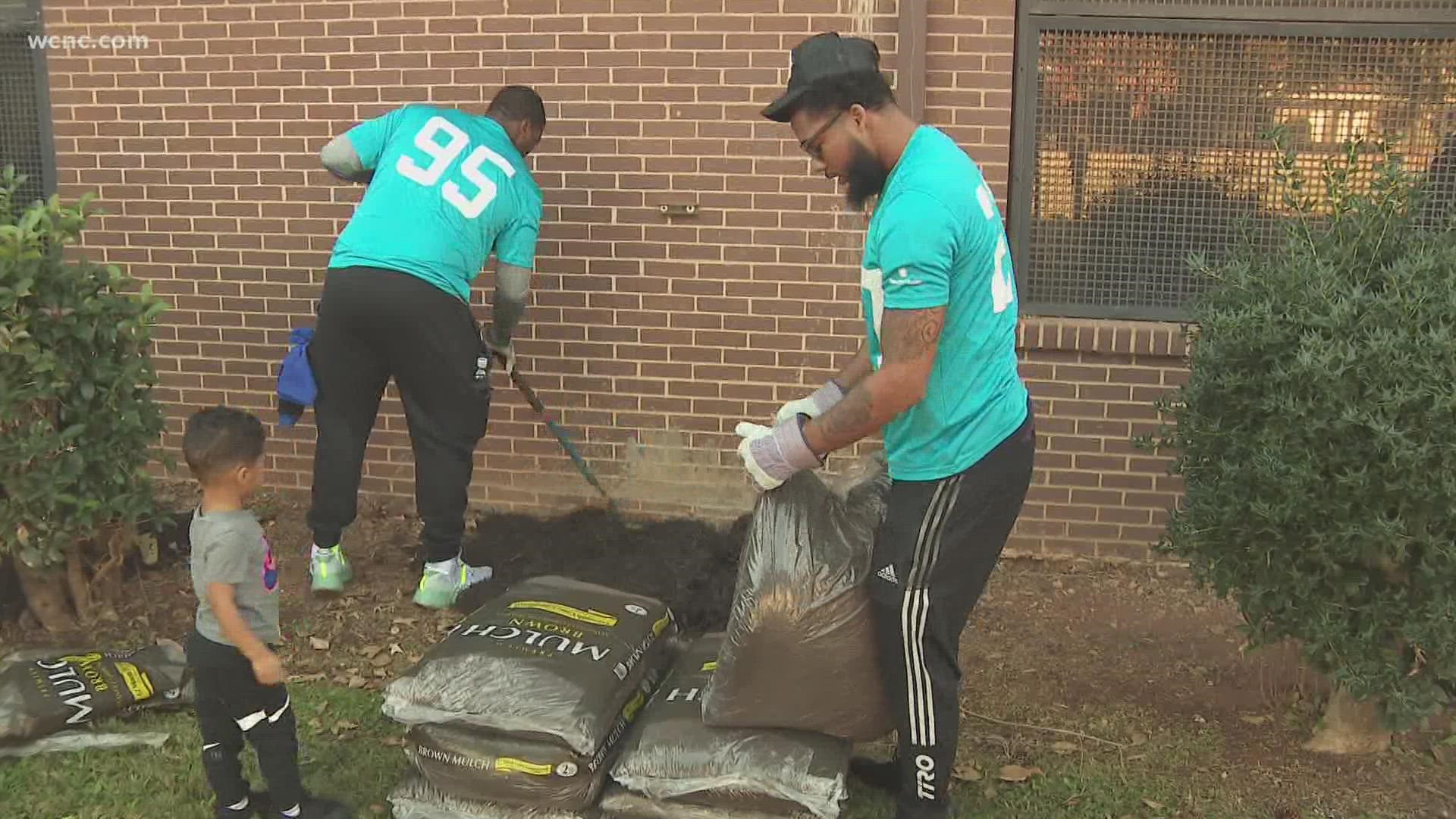 A number of Carolina Panthers spent their off day at Harding High School to help restore and refresh the school's quad.
