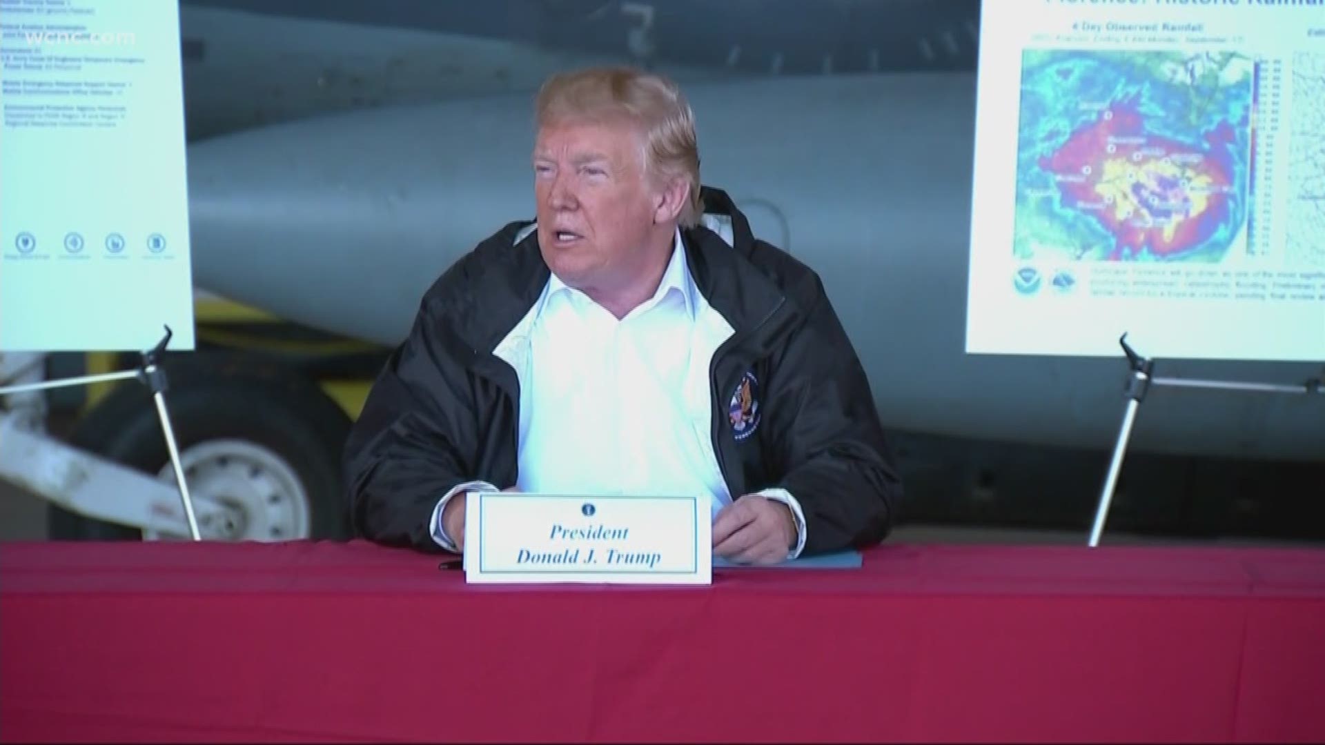 Handing out hot dogs, hugs and comforting words, President Donald Trump sought Wednesday to soothe those who suffered losses in Hurricane Florence, declaring that "America grieves for you" as he surveyed damage the powerful storm left behind.