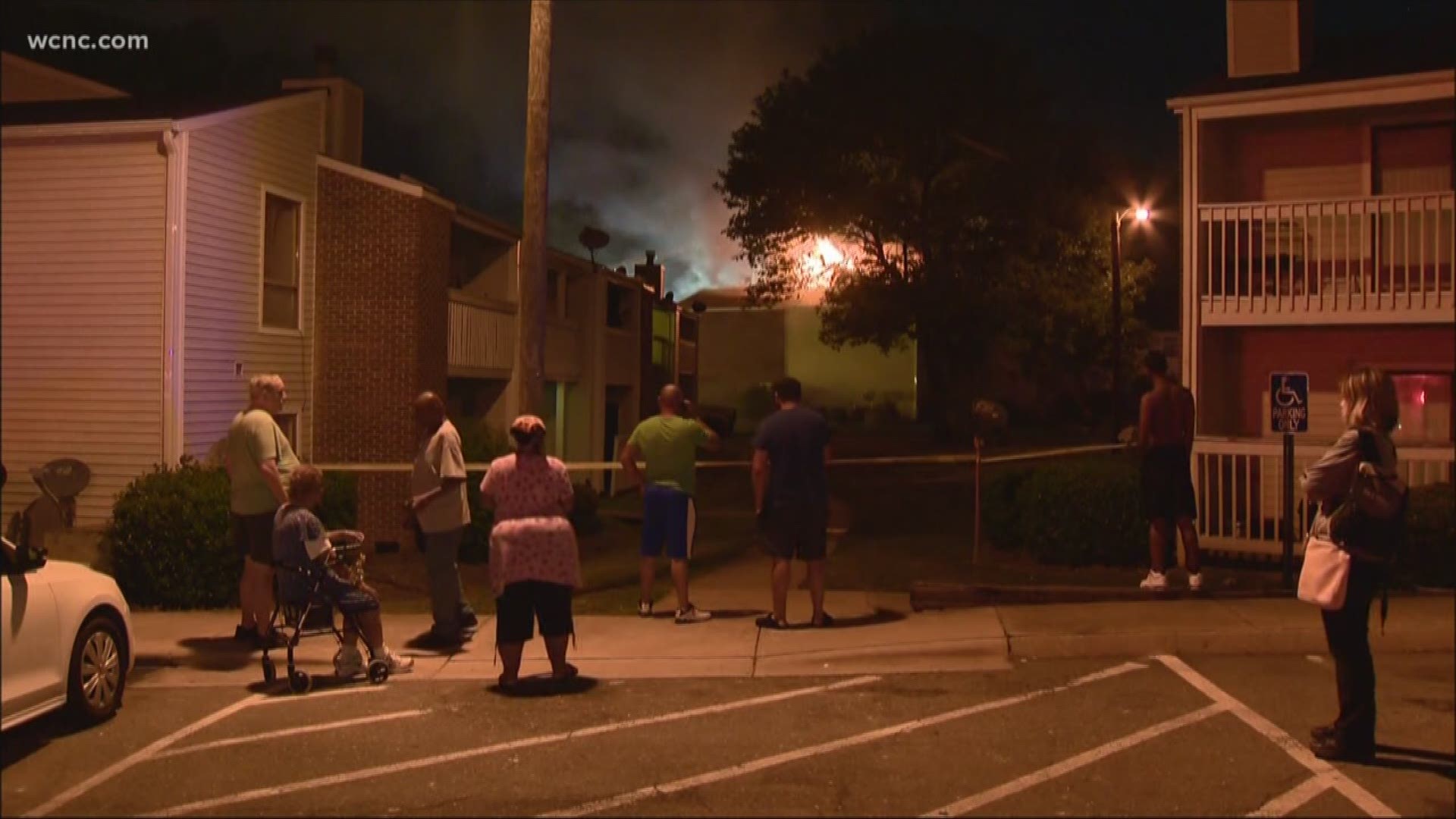 A massive two-alarm fire that left four people hurt in east Charlotte Friday morning was started by a lit cigarette.