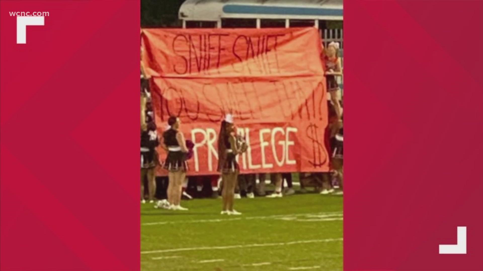 The banner, which was held up before the team ran onto the field, said, "Sniff, sniff. You smell that? $ Privilege $"