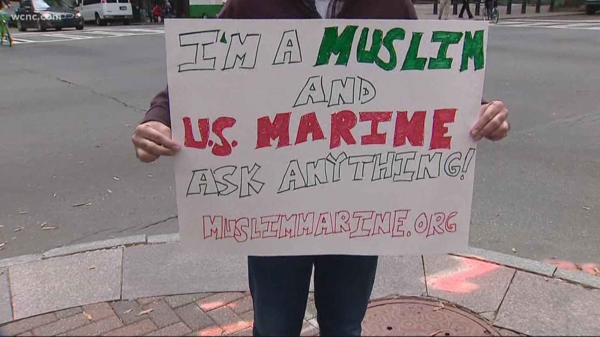 Holding a sign that reads: "I'm a Muslim, and a U.S. Marine Ask Anything" Mansoor Shams walked around the Trade & Tryon trying in his own way to make the world a more peaceful place.