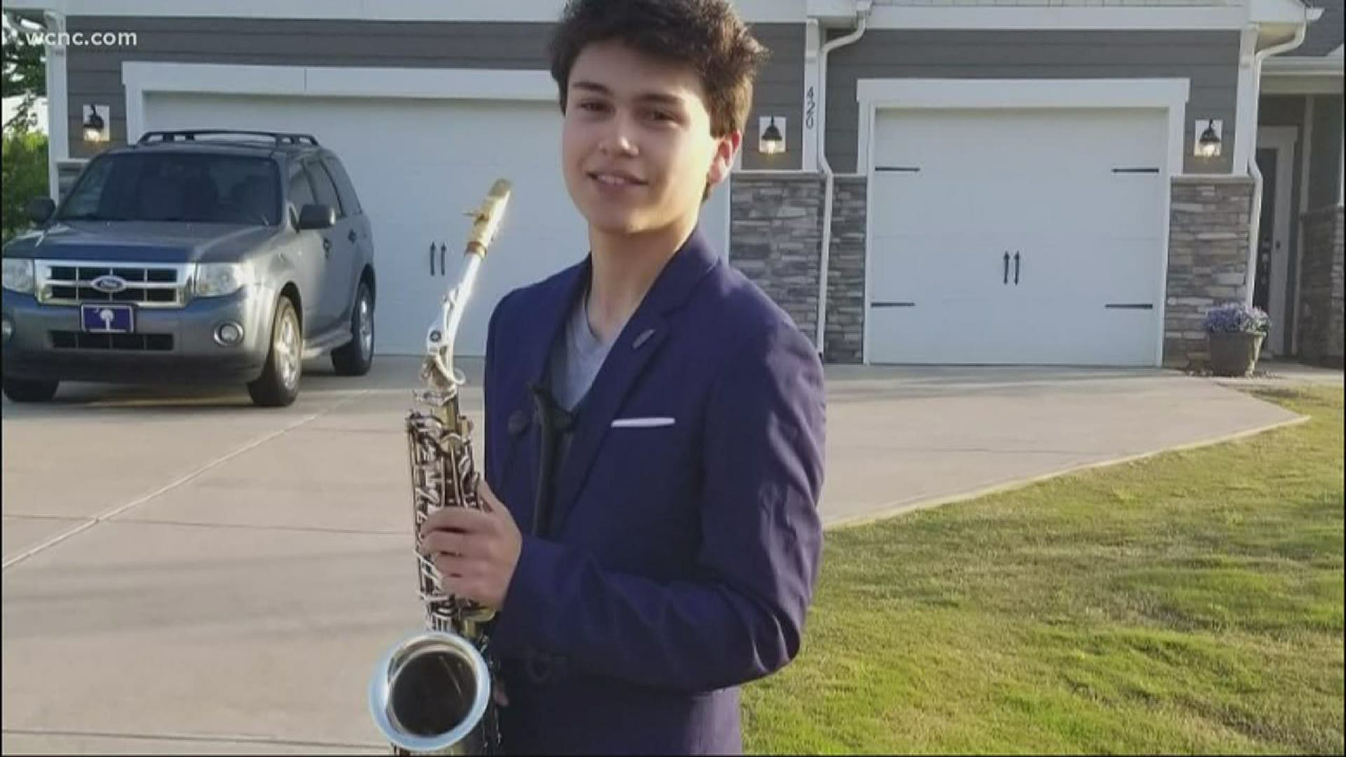 The teen is going to houses and, from a safe distance, playing them music on his saxaphone.