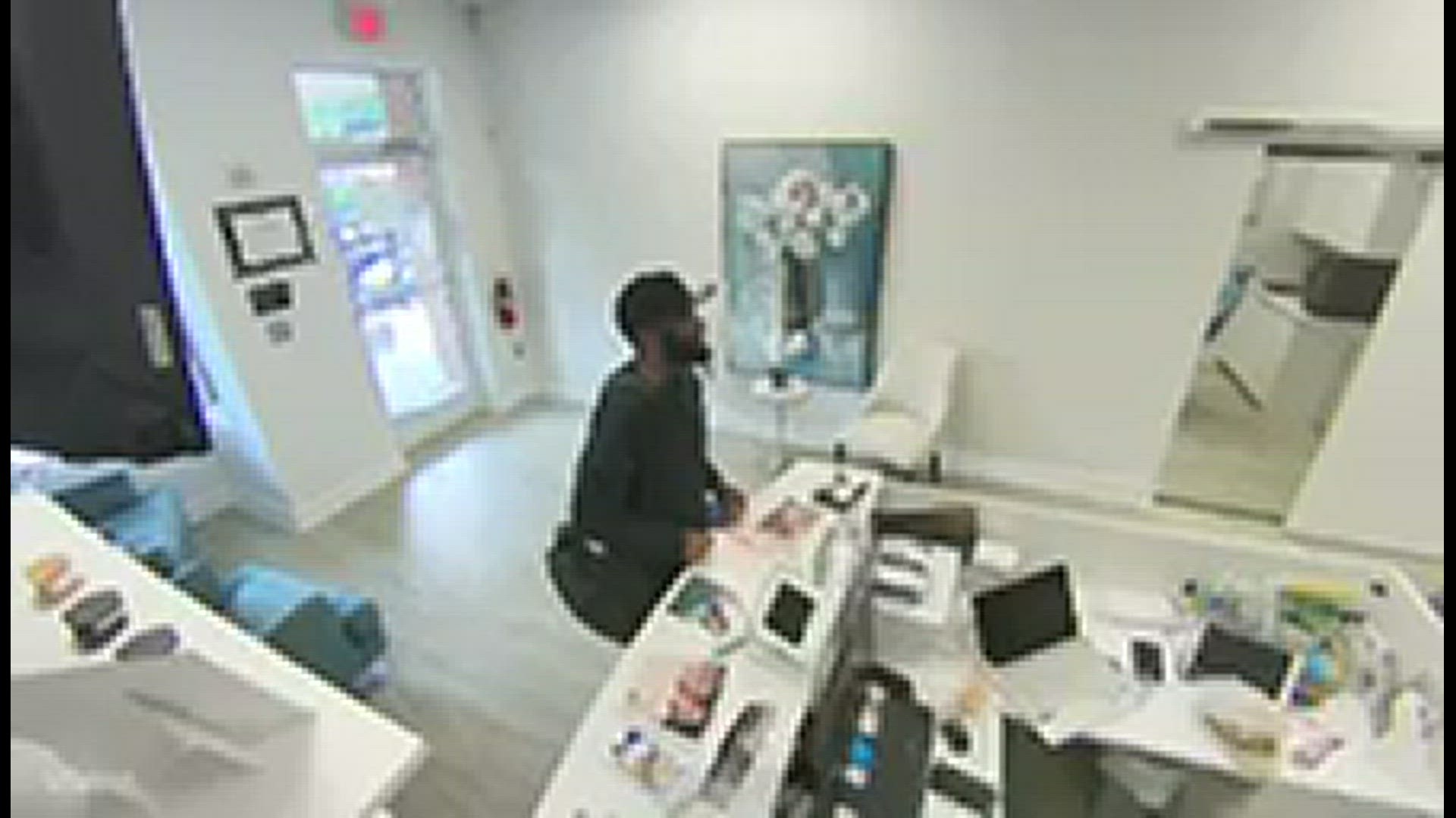 Video footage shows the suspect taking pictures and stealing a dentist's license off the wall.