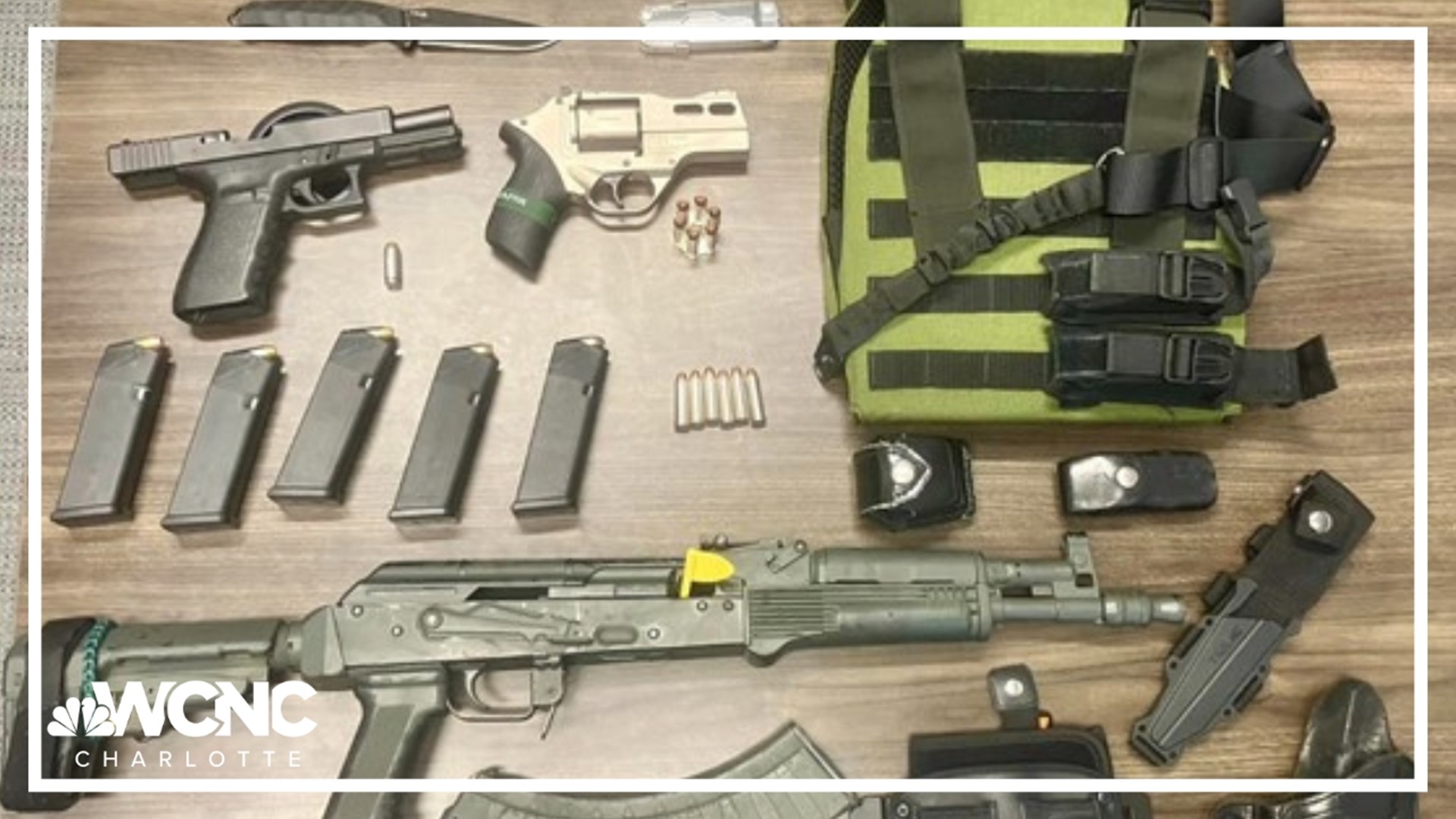 An officer found the man wearing a bulletproof vest, carrying an "assault-style" rifle and with multiple handguns.