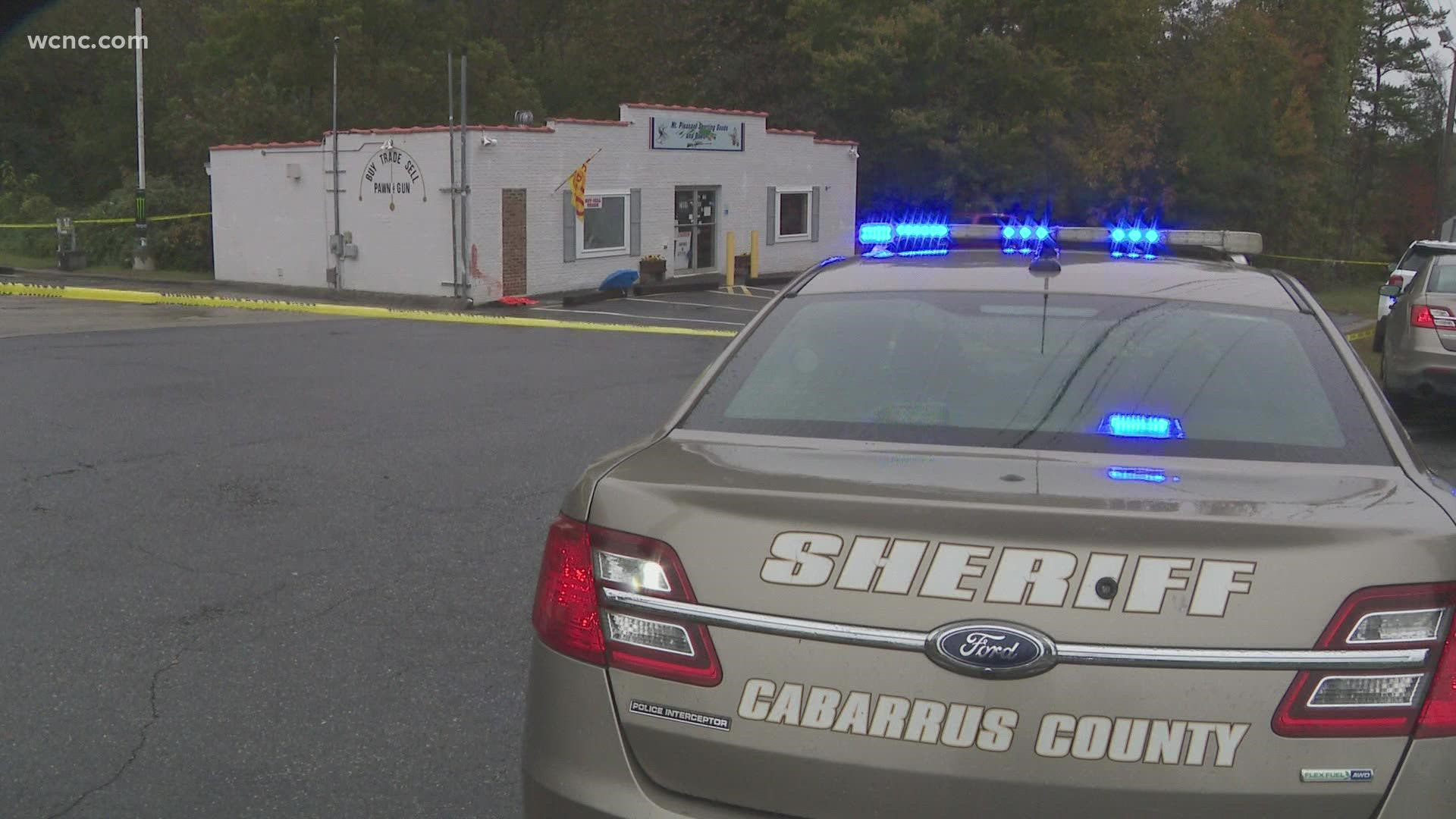 An off-duty officer opened fire at a group of suspects accused of shooting a pawn shop owner during an armed robbery in Cabarrus County Thursday, police said.