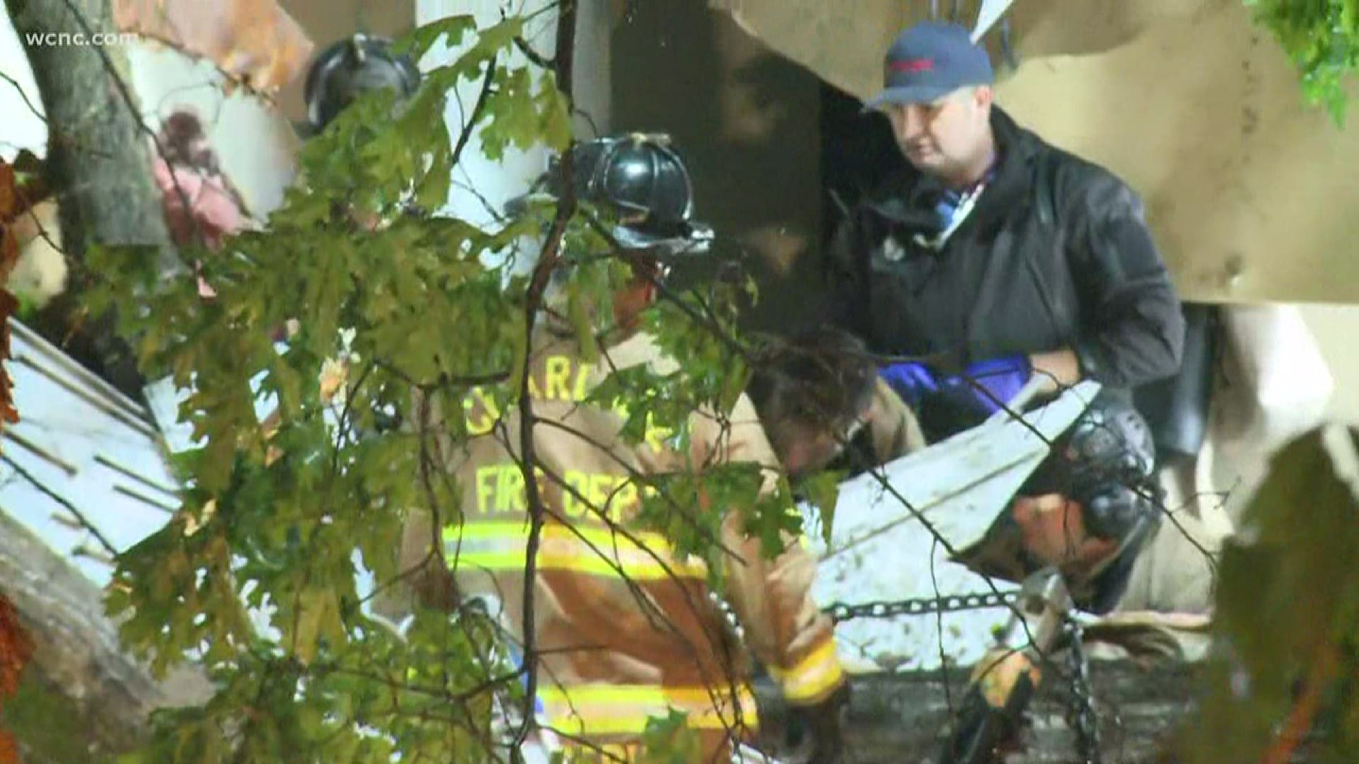 A woman was trapped inside a south Charlotte apartment building when a tree fell during Monday morning's severe weather.