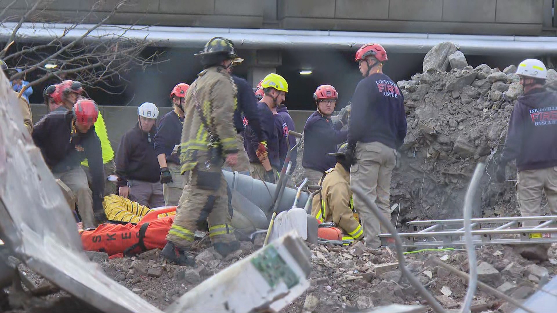 A worker trapped in rubble at a Louisville construction site Thursday is breathing, but a rescue could take hours, according to Louisville Fire.